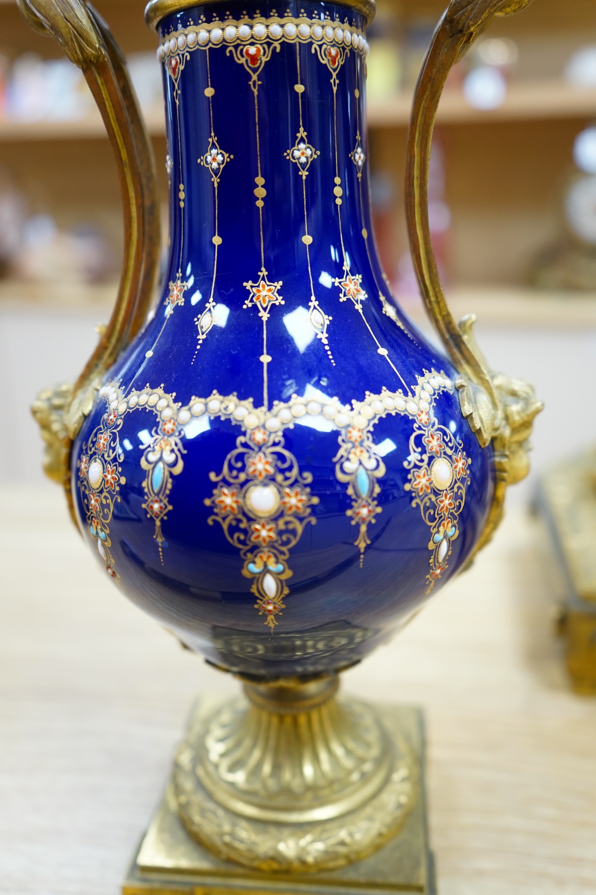 A 19th century Sevres style jewelled porcelain and ormolu matched clock garniture, striking on a bell, with pendulum, 51cm high. Condition - fair to good, minor restoration, untested